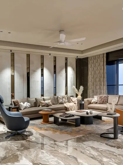 At the heart of this 3,300 sq. ft. luxury residence in Shivaji Park, the living room brings together understated elegance and refined functionality. A statement wall etched in marble with ancient texts seamlessly blends heritage with modern design language.