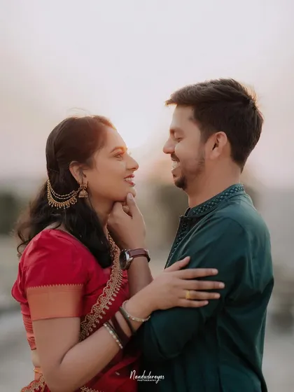 A sweet moment captured as the bride gently touches the groom's chin, their expressions full of affection.