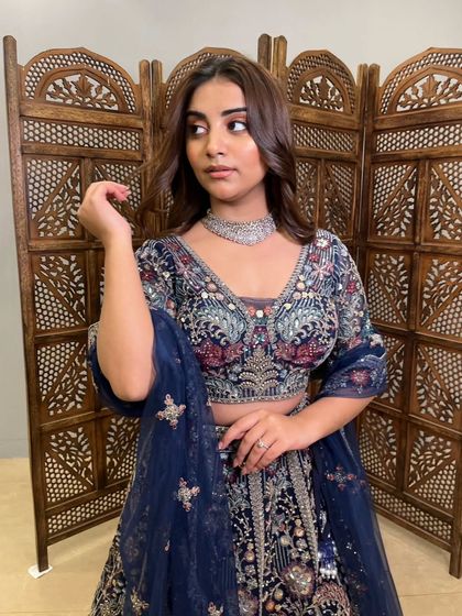 A portrait shot that captures the sophisticated and regal feel of this heavily embroidered pre-loved lehenga.