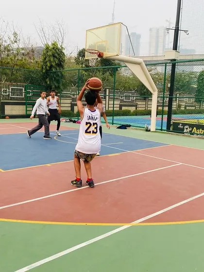 A young player practices his shooting form from mid-range.