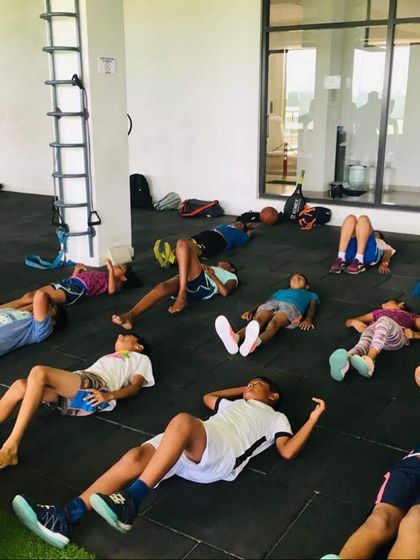 Cool-down and recovery are just as important as the workout itself. Here, the group takes a moment for guided stretching and breathing exercises after a tough session.