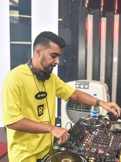 A shot of me at the console, focused on the mix. The fan in the background is a must-have for high-energy sets.