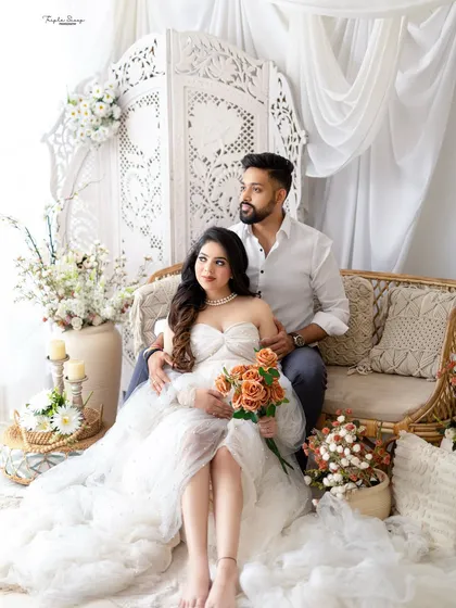 A relaxed and romantic pose for the expecting couple on the studio couch. The mom-to-be is wearing a beautiful white lace gown from my client closet.