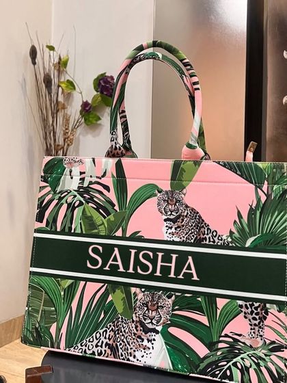 For a wild and chic look, our leopard print tote bag is the perfect choice. The pink and green tropical leaves add a pop of color.