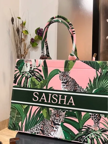 This pink and green leopard print suede tote bag is fierce and fabulous. It's personalised with the name 'Saisha' in a bold font.