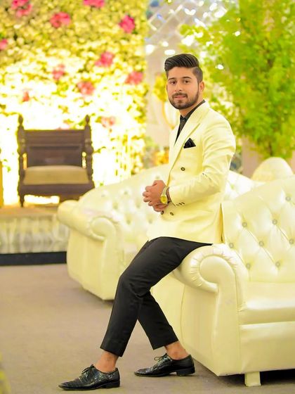 A full shot of the client, showing how the entire look comes together. The white blazer makes a statement, and the grooming ensures he carries it with confidence.