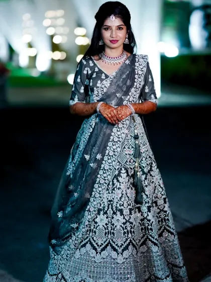 For the reception, we created this stunning look featuring an intricately embroidered grey lehenga. My goal is to design a unique style for each of your events, ensuring you feel beautiful from the first ceremony to the last.