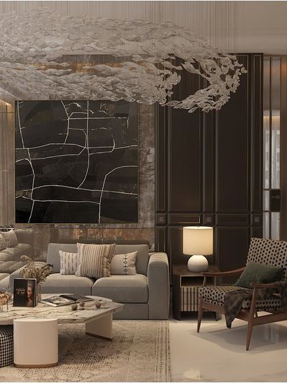 A different configuration of the living space, with a large L-shaped sofa and a patterned armchair. The abstract art and sculptural ceiling light add a modern, artistic touch.