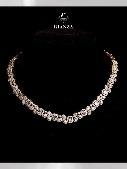 This collar-bone necklace features a stunning array of emerald-cut solitaires, each framed by marquise and pear-shaped diamonds. It is a modern take on classic bridal luxury.