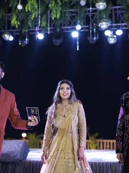 On stage with the happy couple, guiding them through a fun segment. Their smiles are the ultimate reward.