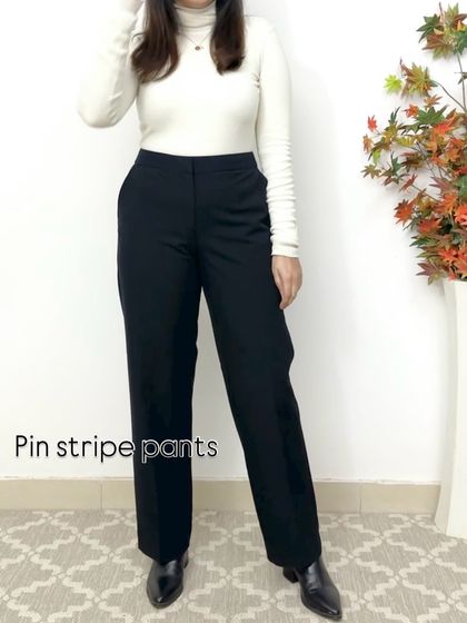 Pinstripe pants are a timeless choice for a sharp, professional look. Paired with a simple turtleneck and boots, they create a clean and classic winter outfit.