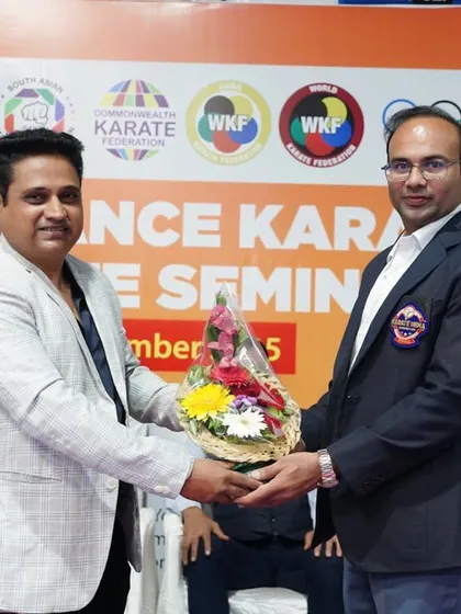 Exchanging greetings with an official at the Pune seminar. Strong relationships with regional bodies are key to organizing successful national-level training events.