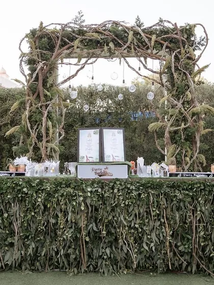 The bar for the safari sundowner was designed to look like a jungle outpost, with a leafy green facade and a rustic vine-covered arch.