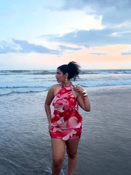 Walking out of the ocean at sunset. This photo captures the dreamy, romantic vibe of a beach evening.
