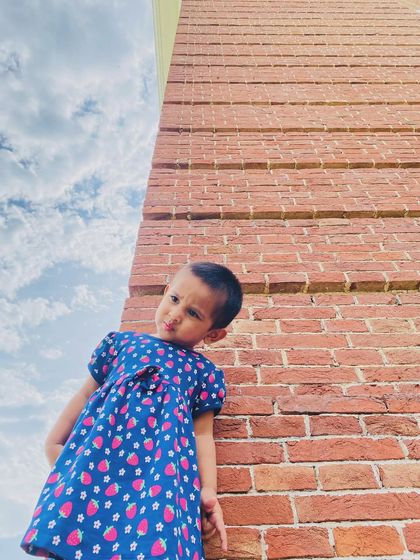 A creative shot of my daughter against a brick wall. I love taking artistic photos of her as she explores the world.