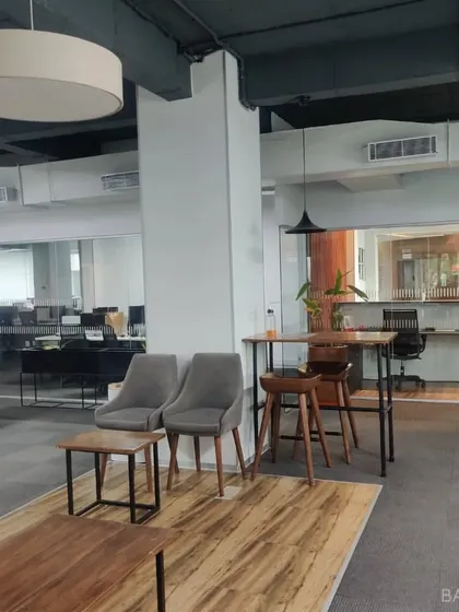 We design office spaces that are more than just desks. This open-plan office includes breakout areas with comfortable seating for informal meetings and collaboration.