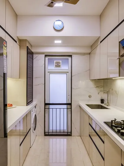 A full view of the parallel laminate acrylic kitchen, showing its clean lines and efficient layout.