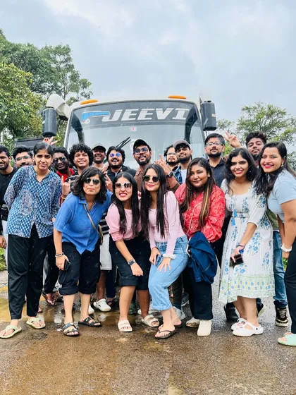 The whole group posing in front of our bus before starting a day of exploration in Coorg. We handle all the transportation, so you can just sit back and enjoy.
