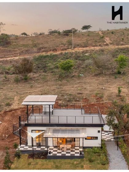 An aerial view of the Denkanikotta home, showing the rooftop deck complete with solar panels. This demonstrates my commitment to building sustainable homes that are also stylish and functional.