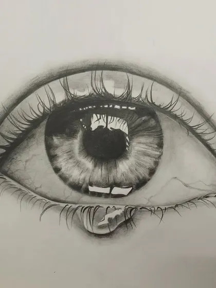 A hyper-realistic drawing of an eye, showcasing incredible attention to detail. The reflection in the pupil, the delicate eyelashes, and the single teardrop are all rendered with precision, making the image feel alive.