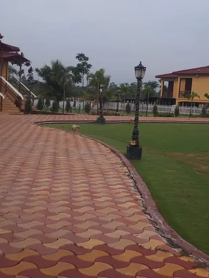 For large properties like this farmhouse, I focus on creating a cohesive landscape design. This includes expansive lawns, well-maintained pathways with interlocking pavers, and strategically placed trees and lampposts for a park-like feel.
