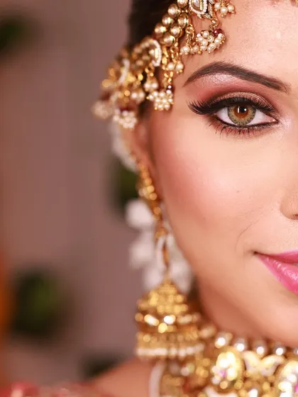 A detailed half-face shot showing the precision of the eye makeup, from the perfectly blended eyeshadow to the sharp winged liner.