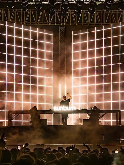The clean, powerful stage design for Dimitri Vegas & Like Mike, featuring a massive grid of white lights.