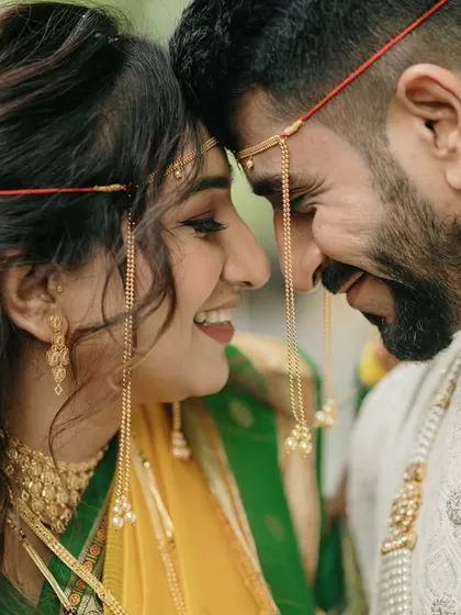 A close-up that captures the playful intimacy between a newly married couple. The shared laughter and eye contact tell a story of deep friendship and love.