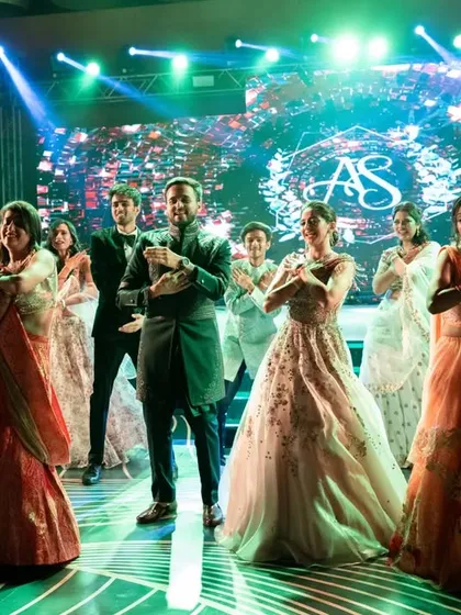The final pose of a perfect flashmob entry. We bring the bride, groom, and their entire squad together for a grand finale that looks amazing on stage and in photos.