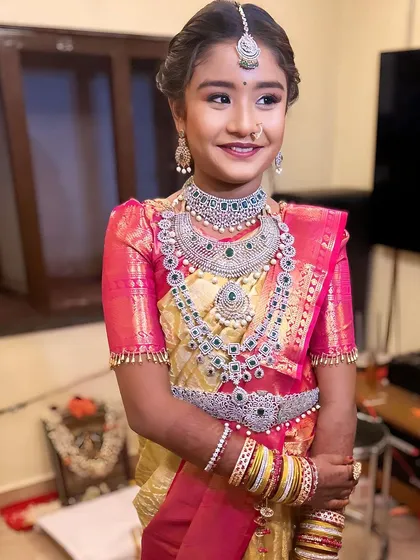 A young girl looking adorable in our American diamond set for a puberty ceremony. This shows our jewellery is perfect for all ages and special occasions.
