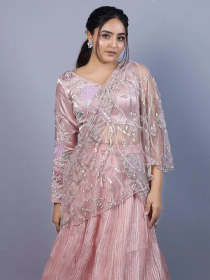 A full view of the baby pink Indo-Western saree from our 'Yuthika' collection. The outfit combines a pleated skirt with a pre-draped, embroidered net pallu for a modern and hassle-free take on the classic saree.