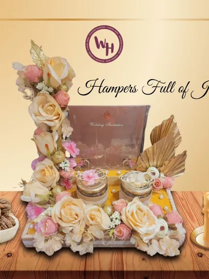 Hampers full of joy. This stunning wedding invitation hamper is decorated with dozens of roses and includes two small jars for sweets or dry fruits.