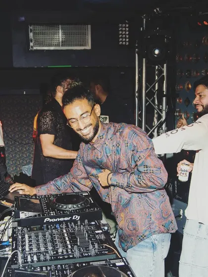 Sharing a laugh with a friend behind the decks. My events are about good vibes and community, and it starts right here in the DJ booth.