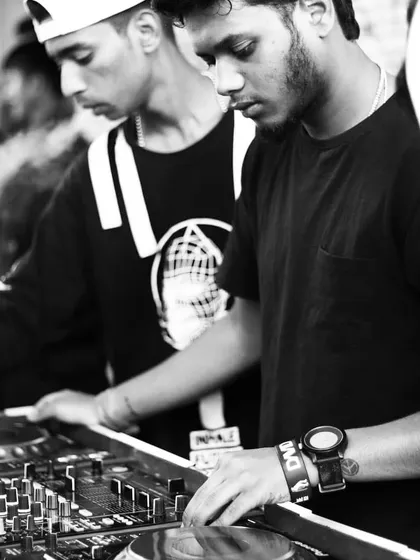 A moment of pure focus. This black and white shot captures the concentration it takes to line up the next track and keep the flow of the music perfect for the dance floor.