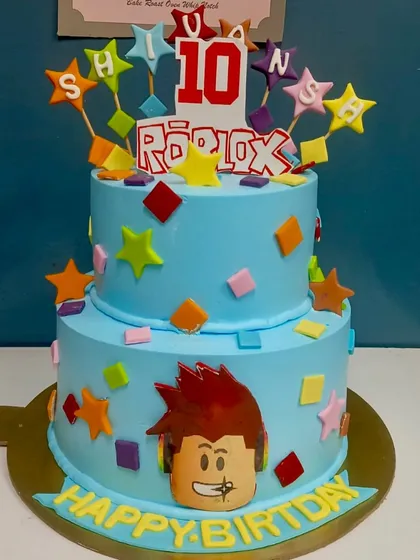 Another take on our popular Roblox theme. This two-tier cake is personalized with the birthday boy's name on colorful stars, ready for his 10th birthday celebration.