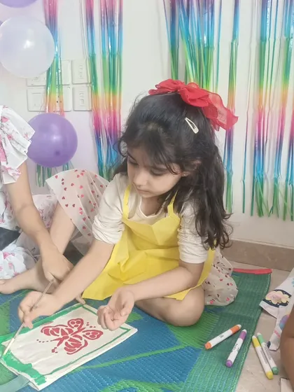 A young artist concentrating on her butterfly design. I love seeing the focus and care kids put into their creations during our birthday workshops.