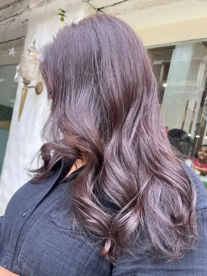 This indoor shot shows the richness of the mauve-brown color. It’s a sophisticated and trendy choice for anyone looking for something beyond a standard brunette.
