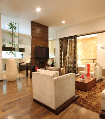 In this older project, our focus was on creating an open-plan living area. By using glass partitions and a consistent wooden flooring, we made the space feel larger, brighter, and more connected.