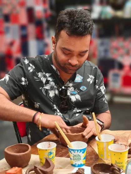 A participant at our corporate workshop focuses on his hand-built bowl. We provide all the tools and guidance needed for everyone to create something they can be proud of.