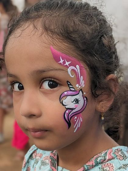 A close-up of a beautiful unicorn face paint, showing the delicate lines and soft colors.