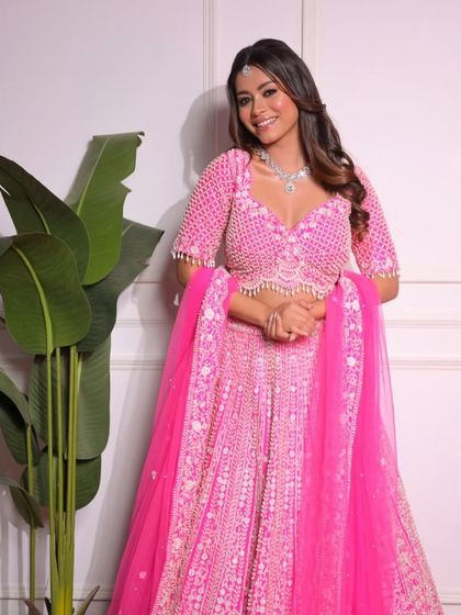 This bright pink lehenga is fun, vibrant, and full of energy. The heavy pearl and sequin work makes it a glamorous choice for a sangeet or ladies' night.