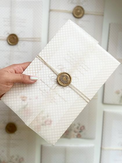 Holding my sister's wedding invitation. It was a true labor of love, from the hand-painted floral design to the calligraphy and assembly.