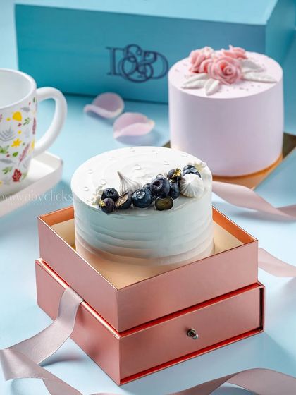 A blueberry mini cake with fresh fruit and meringue, elegantly placed in a pull-out drawer gift box for a premium unboxing feel.
