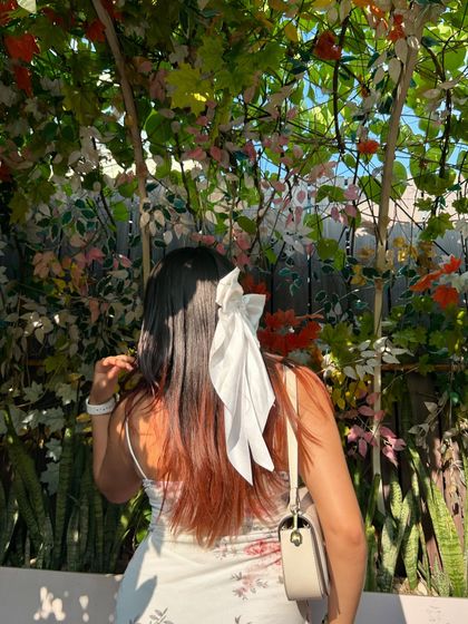 A back view showing my hair bow and the beautiful floral wall. This highlights the small details that make a photo special.