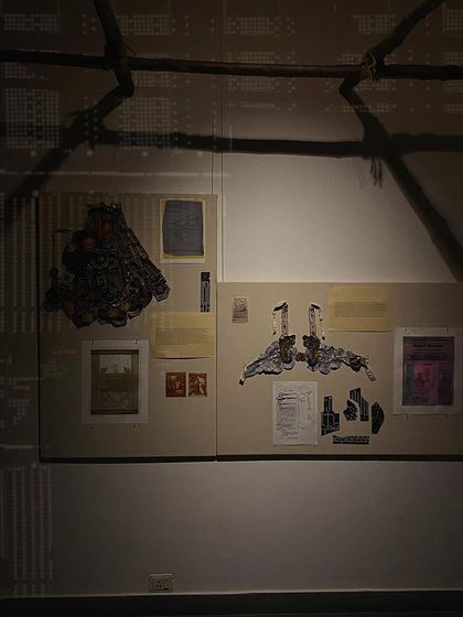 An installation view showing the shadow play from the punch cards on the wall.