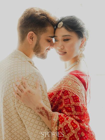 An intimate close-up of Nick and Carrie, forehead to forehead. This high-key photograph focuses on their deep connection and the gentle emotion shared between them.