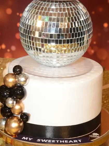 A detailed shot of the disco ball separator, a popular choice for milestone birthday cakes.