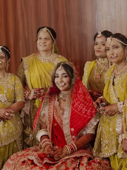 The bride surrounded by her family, looking radiant and happy as the center of attention.