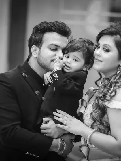 A loving family moment from a first birthday party, beautifully rendered in black and white to emphasize the emotion.
