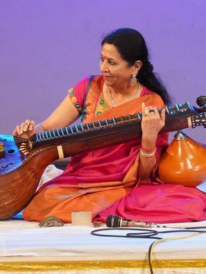 Here I am, performing with my veena at a festival by Sevasadan. Each concert is a new story, and I love sharing the intricate melodies of Carnatic music with the audience.